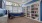 a room with a large window and a bookcase
